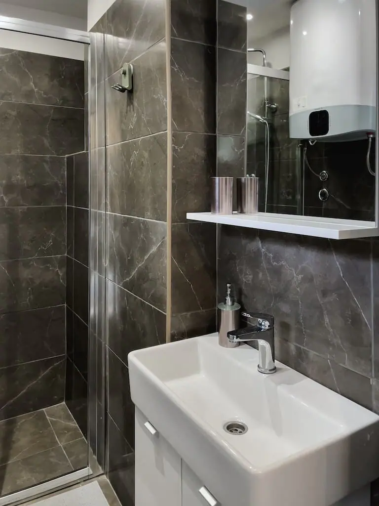 Dark marble bathroom with glass shower