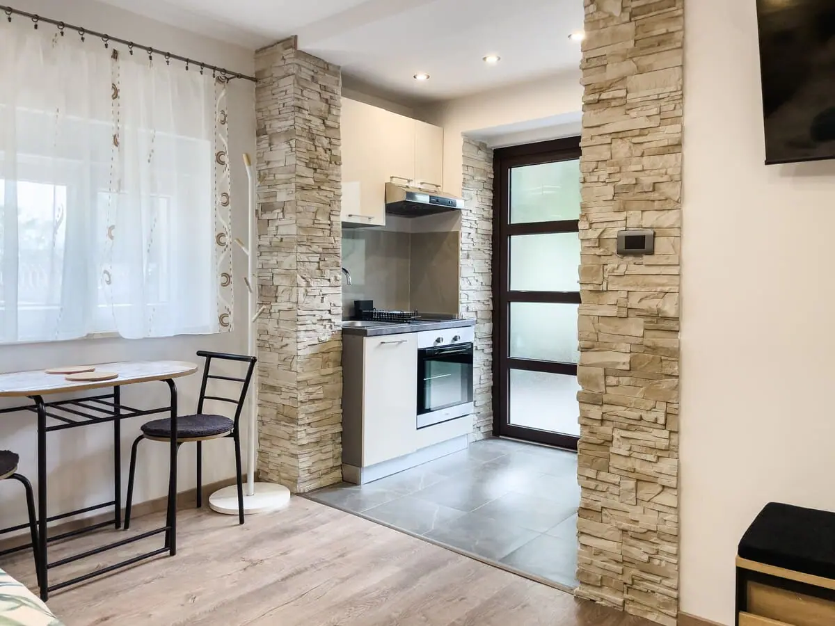 Kitchenette through the stone archway